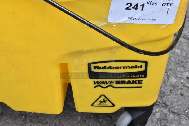 Yellow Rubbermaid WaveBrake mop bucket with wringing attachment on commercial casters. Features caution label.