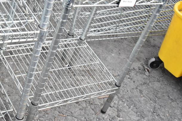 Chrome finish 6-tier wire shelving unit, durable metal construction. Buyer must dismantle; check freight charges. Over-stock tag visible.
