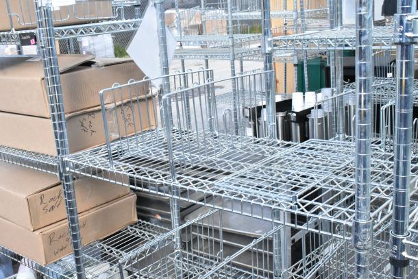 Chrome finish 6 tier wire shelving unit with visible cardboard boxes, dismantling required by buyer, freight charges applicable.