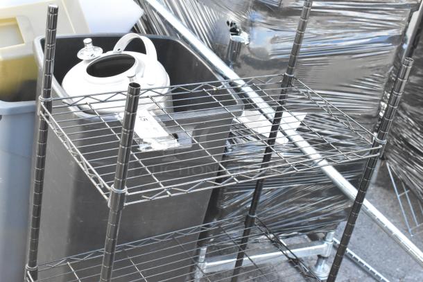 Black wire shelving unit with multiple shelves, a small white container, and plastic bins. Part of a five-item auction lot.