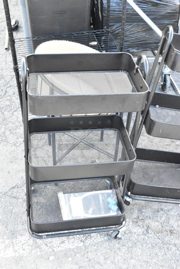 Black wire shelving unit with three mesh trays, on wheels. Includes folding chair, cart, and additional items.