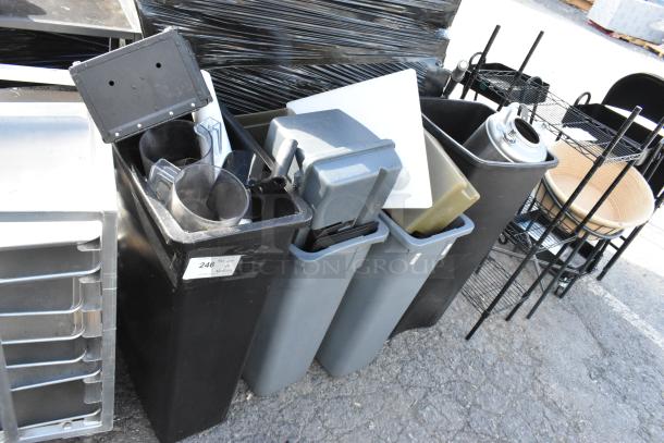 Four poly trash cans with various contents including a keg, plastic pitchers, and trays. Label "246" visible. Auction lot.
