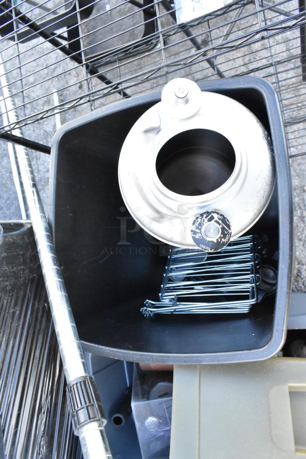 Four poly trash cans with contents, including a keg and wire racks, in used condition.