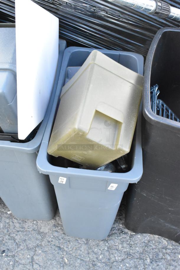 Four poly trash cans filled with various items, including a keg. Features sturdy gray and black construction. Used condition.