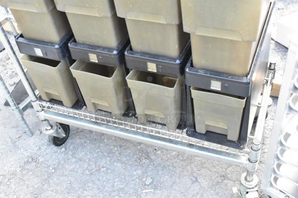 Metal cart with commercial casters, holding six poly beverage dispensers. Used condition, sturdy construction.