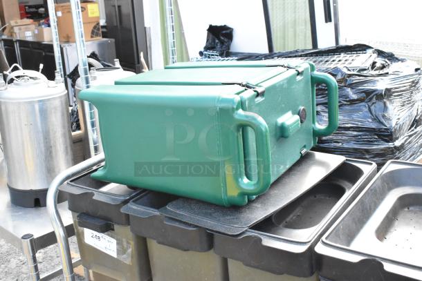 Metal cart with commercial casters featuring green poly beverage dispensers, good condition, label with quantity visible.