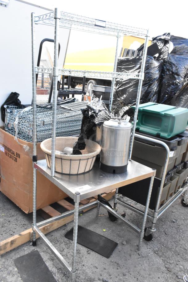 Metal stand with two shelves, includes keg and basket. Used condition, sturdy construction, suitable for storage or display.