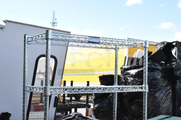 Metal stand with multiple shelves, containing a keg. Appears sturdy and in good condition. Located outdoors.