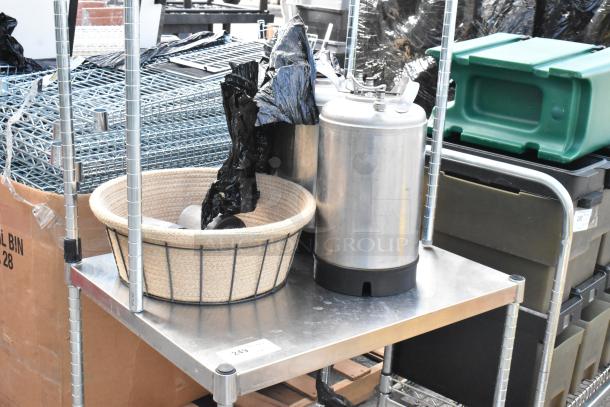 Metal stand with contents, including a stainless steel keg and basket, visible on lower shelf. Item tagged "243."