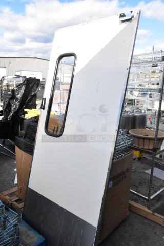 Metal swinging kitchen door with an oval window, white finish, minor scratches, industrial use, sturdy steel construction.