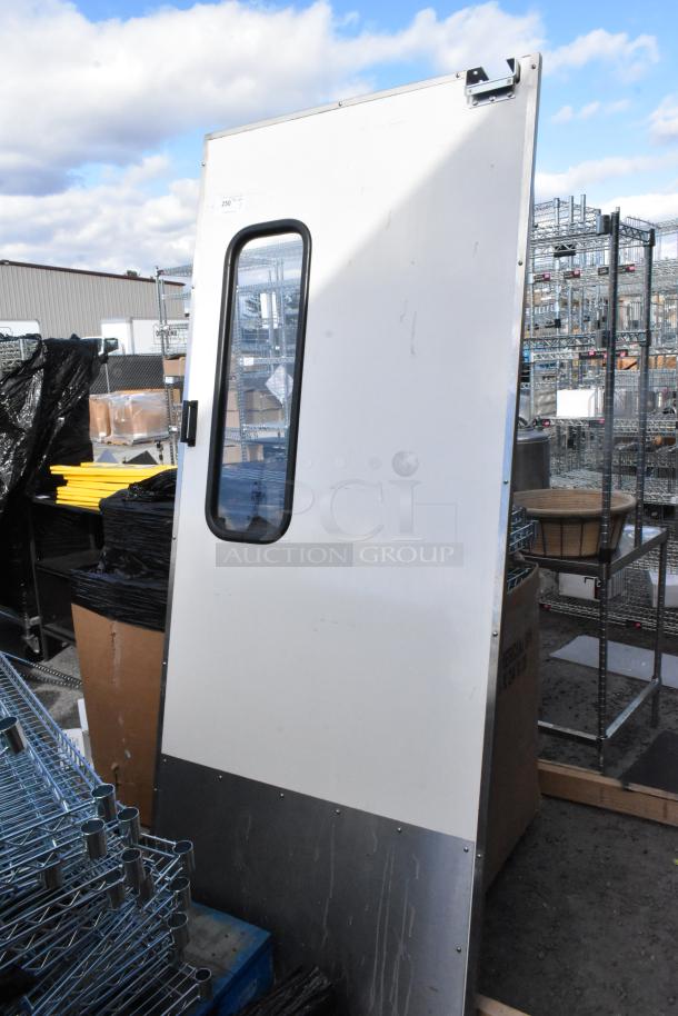 Metal swinging kitchen door, white with metal lower panel, rectangular window, and attached hinge. Good condition.