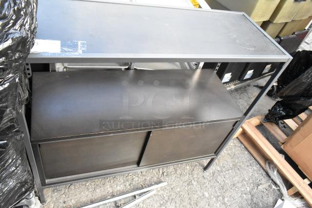 Black metal and wood television stand, dual shelves, sliding doors, slight surface wear, auction tag on top.