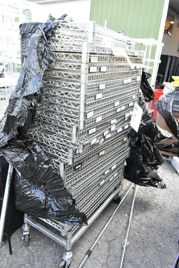 Chrome finish 25-tier wire shelving unit on commercial casters, excellent condition. Buyer must dismantle, freight charges apply.