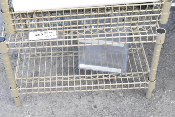 Tan finish wire shelf with water filtration cartridge. Instructions indicate buyer must dismantle. Consider freight charges.