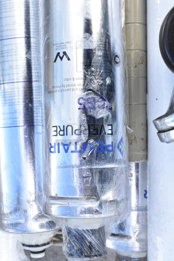 Tan wire shelf with Pentair Everpure water filtration cartridges, wrapped, buyer must dismantle. Consider freight charges.