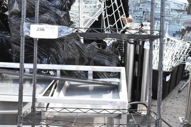 Black 6-tier wire shelving unit, dismantled, black finish. Buyer must dismantle for shipping; freight charges apply. Tags with lot info visible.