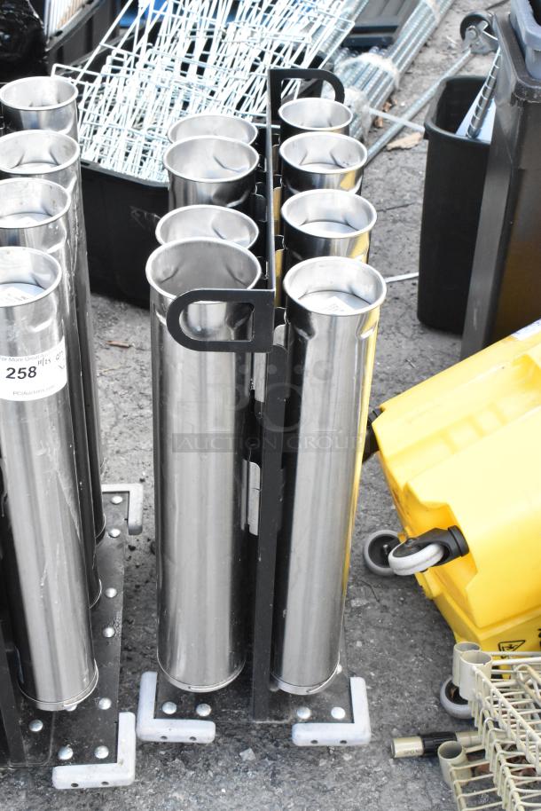 Two metal carts with eight stainless steel cup dispensers each, sturdy construction, and attached wheels, auction tagged.