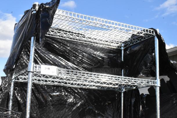 Chrome finish 6-tier wire shelving unit with contents. Visible black cover. Buyer must dismantle. Item tag 259.
