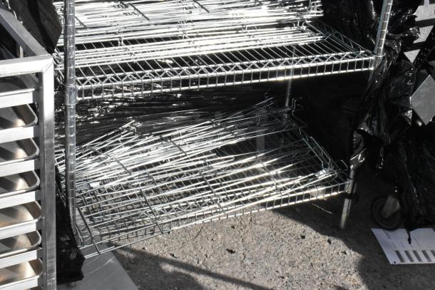 Chrome 6-tier wire shelving unit with contents, dismantled. Reflective finish, sturdy wheels. Buyer must dismantle.