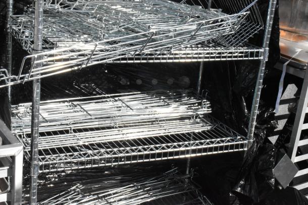 Chrome finish 6 tier wire shelving unit with contents, in good condition. Buyer must dismantle for shipping; freight charges apply.