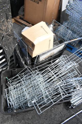 Lot of various metal pieces and wire racks in used condition. Includes Vitamix-labeled box and assorted metal parts.