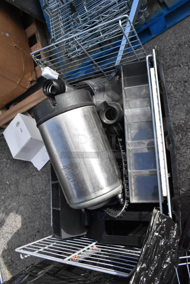Lot of items including a keg, metal shelving pieces, various containers, and mechanical parts, in mixed condition.