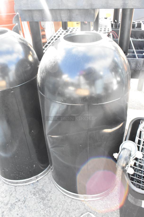 Two black metal trash can shells in gently used condition, glossy finish, no visible labels.