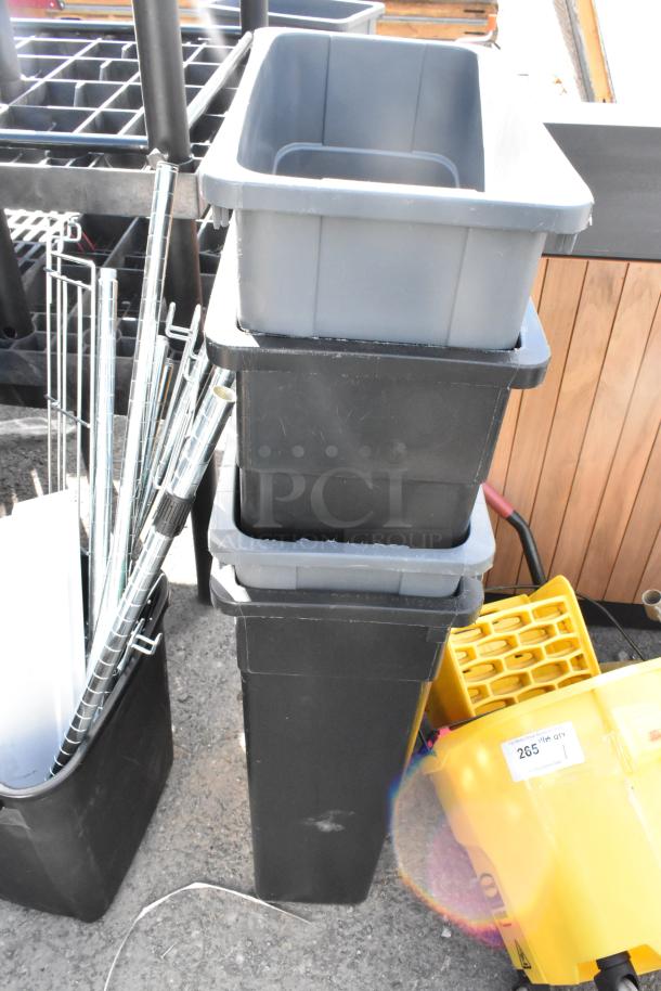 Stack of five poly trash cans including four Slim Jim models, in used condition, with visible wear marks.