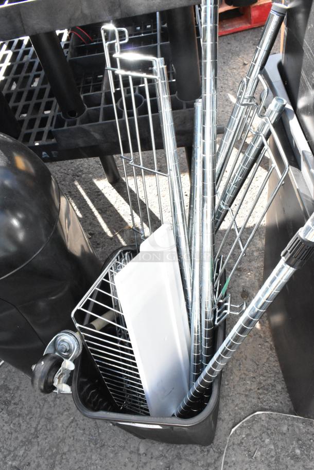 Five poly trash cans, including four Slim Jim models, stacked with metal racks and poles. Used condition.