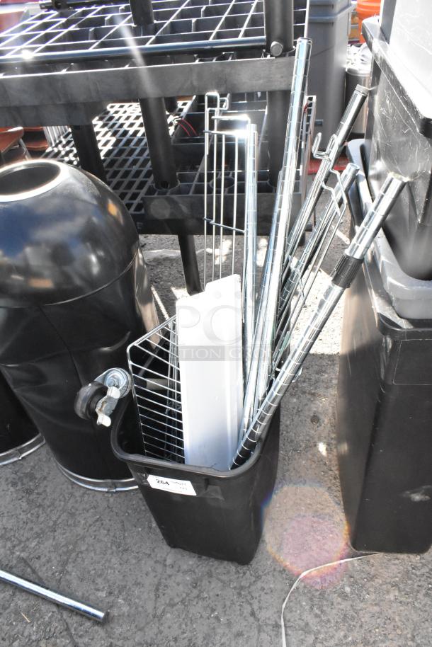 Five various poly trash cans, including four Slim Jim models in black, shown outdoors with metal accessories.