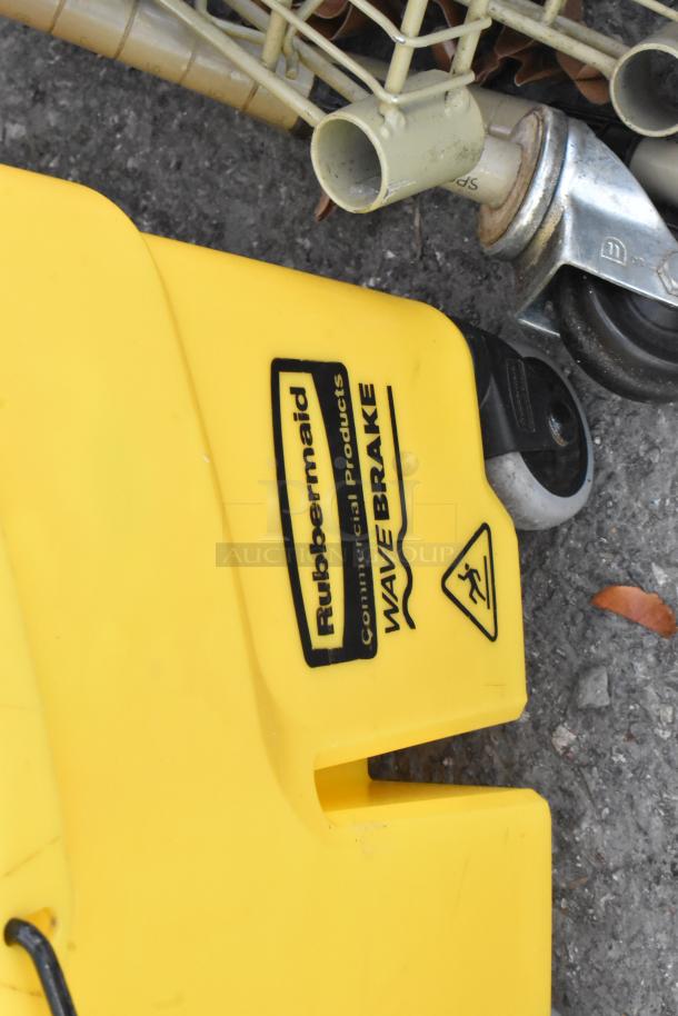 Yellow Rubbermaid Wave Brake mop bucket with wringer, on commercial casters. Visible logo and caution symbol.