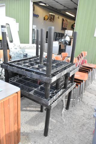 Four stackable black poly tables, sturdy grid design, good condition, suitable for indoor/outdoor use.