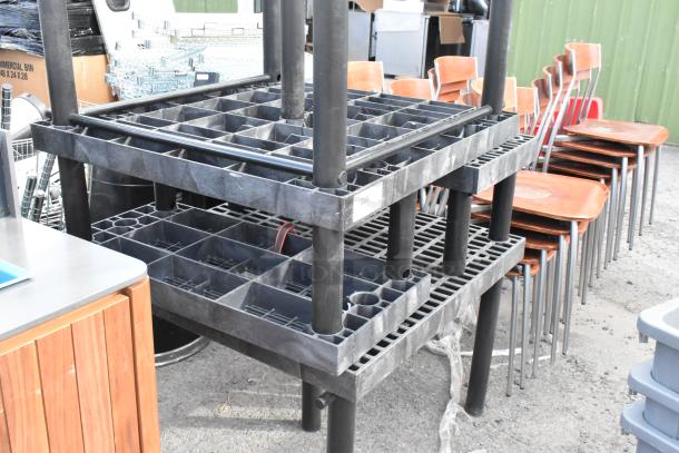 Four black poly tables, stackable design, robust construction, lightly used. Lot label "268" visible, ideal for industrial use.