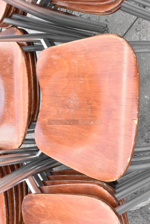 25 wooden dining height chairs with chrome finish frames, visible wear on wood, suitable for bulk purchase.