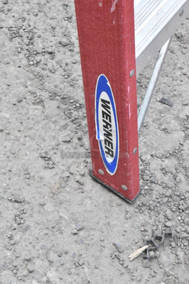 Werner A Frame Ladder, red side rail with logo, sturdy condition, metal steps visible. Ideal for safe, elevated access.