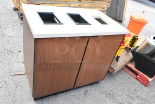Wood pattern trash can shell with three deposit holes, dual doors, and white top. Some visible wear, suitable for commercial use.