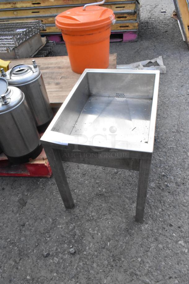 Metal bin on legs, rectangular shape, no visible markings. Used condition with minor wear. Suitable for industrial use.