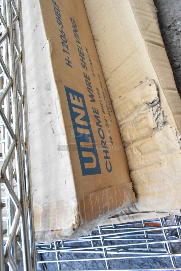 Lot of ULINE chrome finish wire shelves, includes damaged packaging. Model H-1206 with dimensions 48x24 inches.