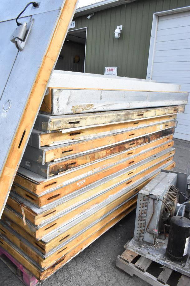 14'x8' Bally walk-in freezer box components, including panels and a Copeland compressor, stacked for removal. No floor included.