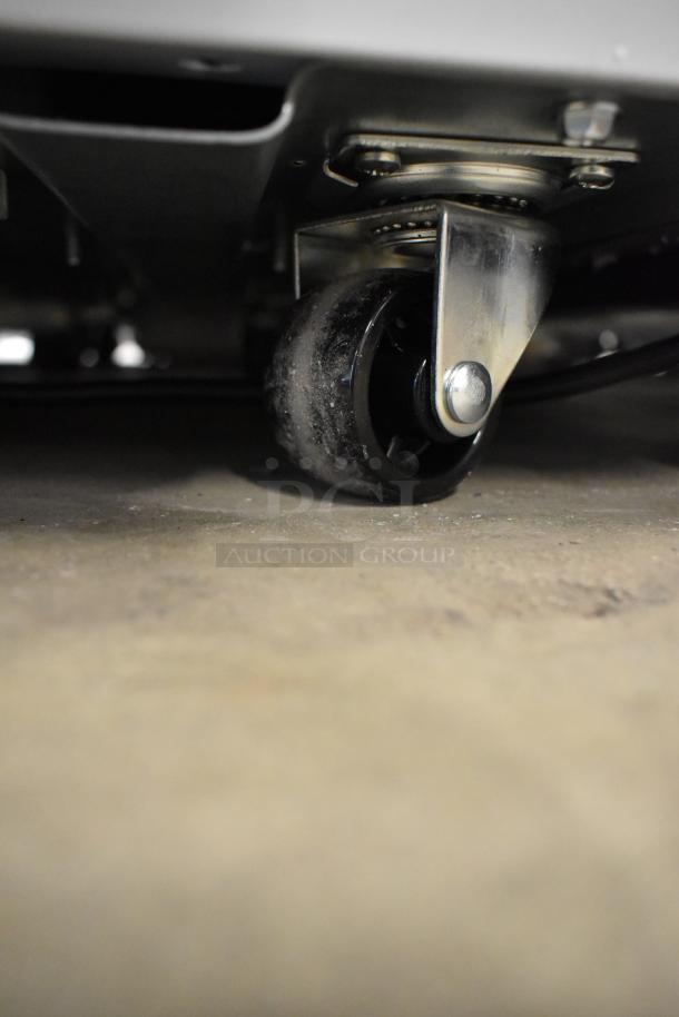 KoolMore MCF-16C Display Ice Cream Freezer caster wheel, shown in detail. New with minor cosmetic scratches. 115 Volt, 1 phase.