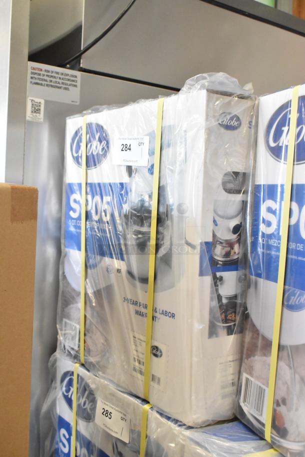 New Globe SP05 5 Quart Metal Dough Mixer in box, 115 volts, 1 phase, with warranty. Box shows model and branding.