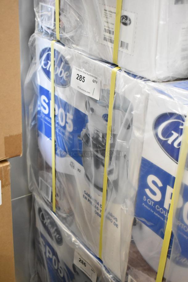 Brand new Globe SP05 5 Quart Planetary Mixer in sealed box. Metal countertop model, 115V, 1 Phase. Auction tag visible.