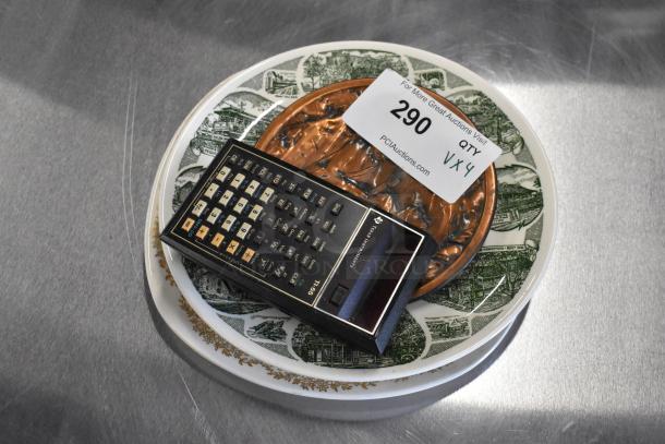 Vintage Texas Instruments calculator on decorative plates with auction label “290” from PCIAuctions.com.