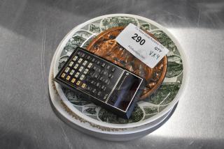 Vintage Texas Instruments calculator on decorative plates with auction label “290” from PCIAuctions.com.