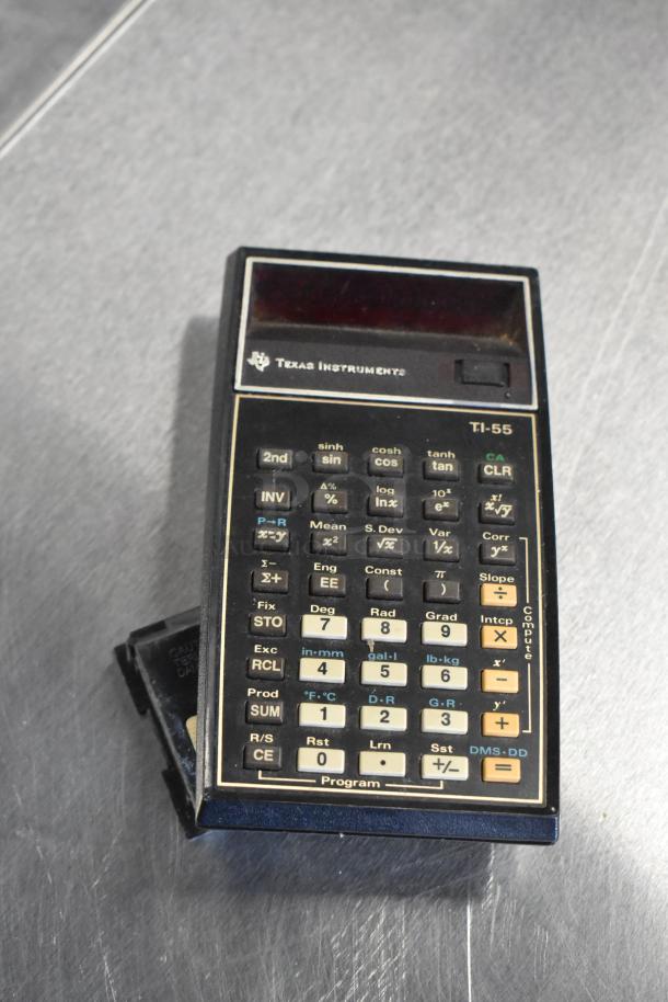 Texas Instruments TI-55 calculator, vintage model, with worn keys, visible markings, and black casing.