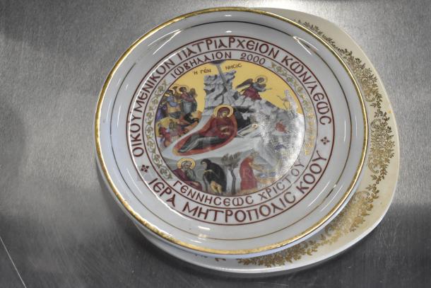 Decorative porcelain plate with religious motif, Greek text, gold trim, and intricate border design. Excellent condition.