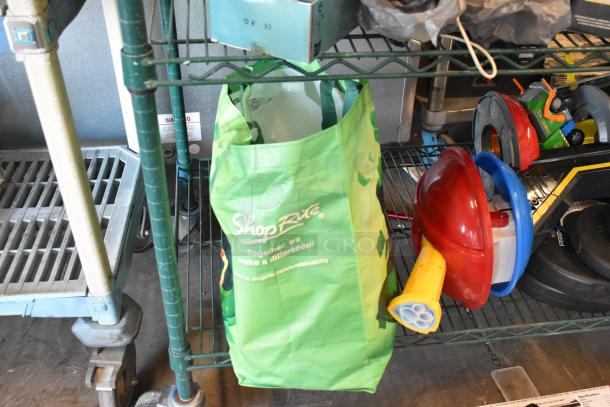Two-tier lot with various items including fishing lures, windchimes, a Nintendo Switch controller holder, and a green ShopRite bag.