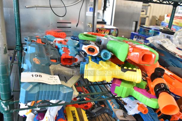 Two-tiered shelf with various toy guns, including Nerf models, in colorful designs. Condition appears used. Tag reads "198, Tier 64."