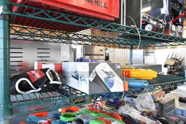 Two-tier shelf with Sony speaker, Jacob doll, Star Wars Darth Vader doll, jerseys, gloves, and assorted items.