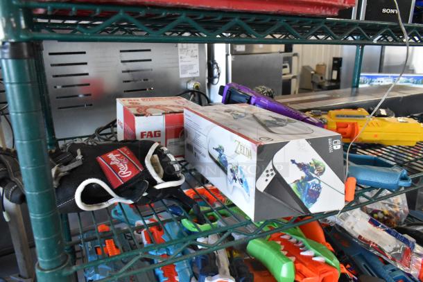 Two-tier auction lot with Sony speaker, Rawlings glove, Zelda-themed box, assorted toys, and FAG bearings box on shelves.